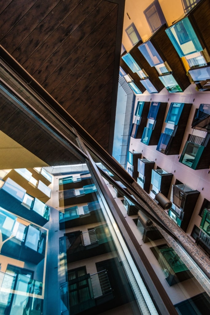 Looking up at an apartment block reflected in a window, Castle Quay, St. Helier, Jersey, Channel Islands