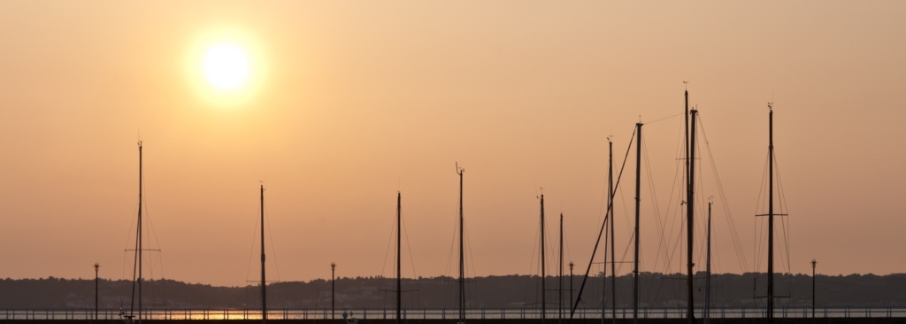 Boat masts at sunset at St. Helier Marina, St. Helier, Jersey, Channel Islands.