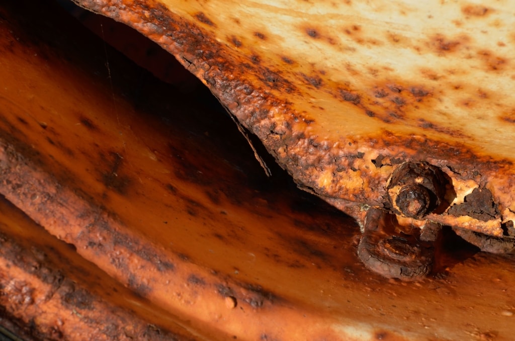 Close up showing coloured and textured rust on a tractor wheel, taken at Seymour Slip, St. Clement, Jersey, Channel Islands