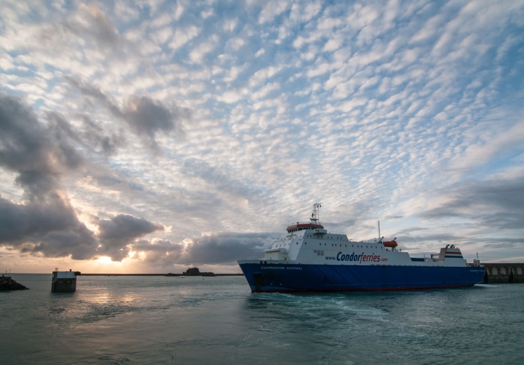 Condor Ferries arriving at the harbour at sunset with beautiful clouds in the sky, Albert Pier, St. Helier Harbour, St. Helier, Jersey, Channel Islands