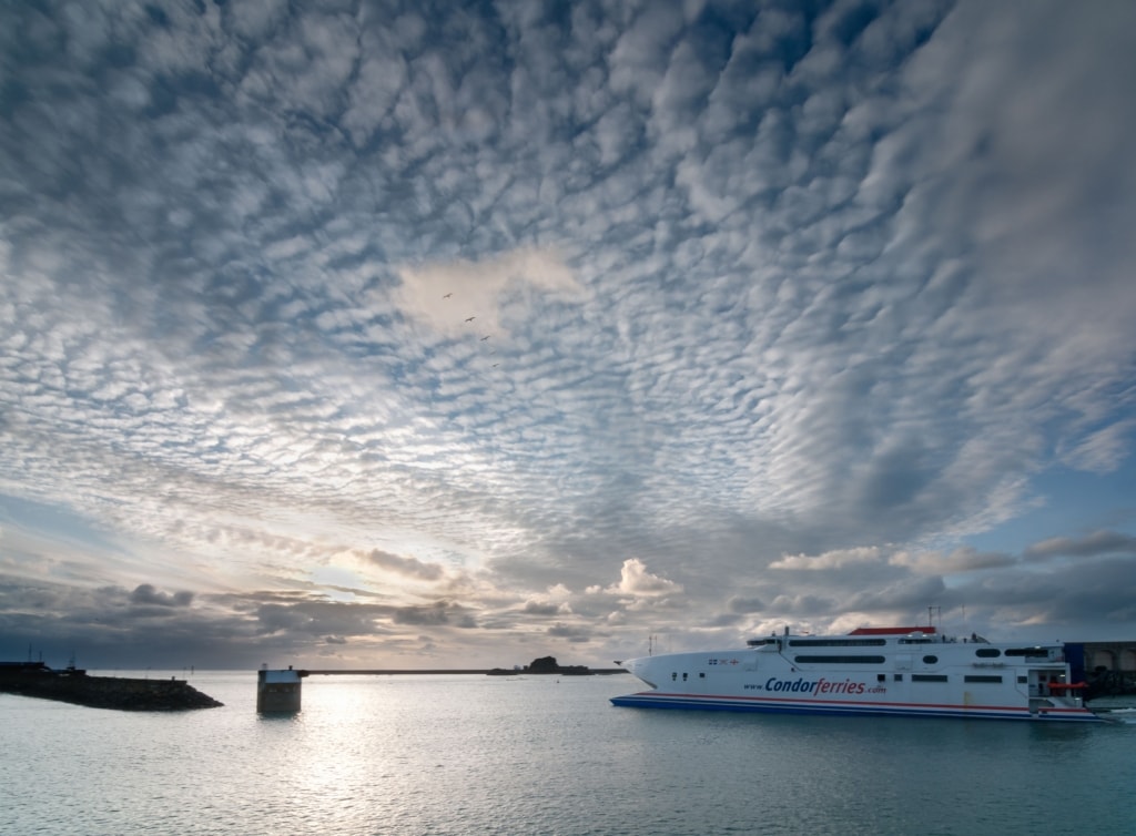 Condor Ferries leaving the harbour at sunset with beautiful clouds in the sky, Albert Pier, St. Helier Harbour, St. Helier, Jersey, Channel Islands