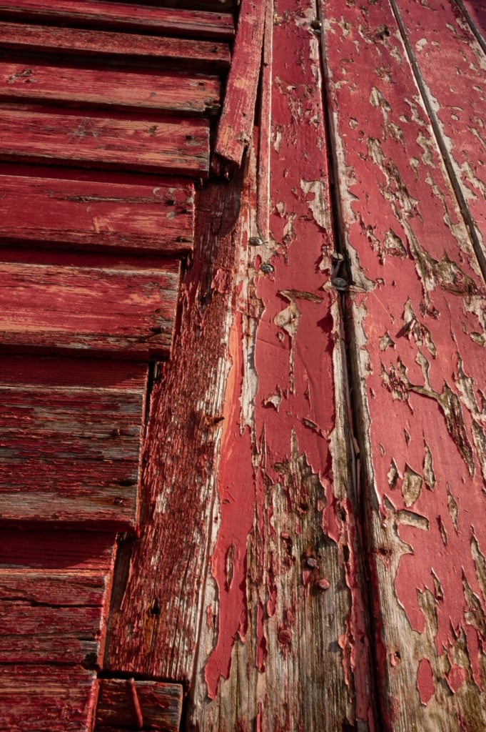 Flaking paint on old red fishing hut on Rozel Pier, Rozel Bay, St. Martin, Jersey, Channel Islands