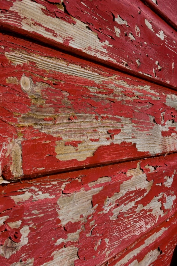 Flaking paint on old red fishing hut on Rozel Pier, Rozel Bay, St. Martin, Jersey, Channel Islands