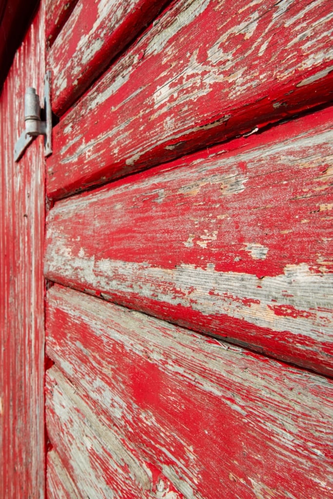 Flaking paint on old red fishing hut on Rozel Pier, Rozel Bay, St. Martin, Jersey, Channel Islands