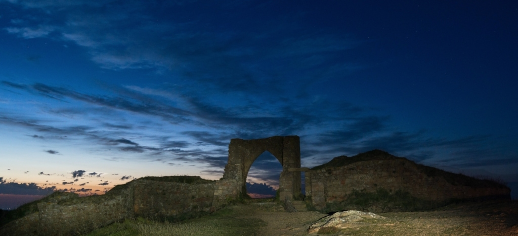 Grosnez Castle ruins after sunset by torch, St. Ouen, Jersey, Channel Islands