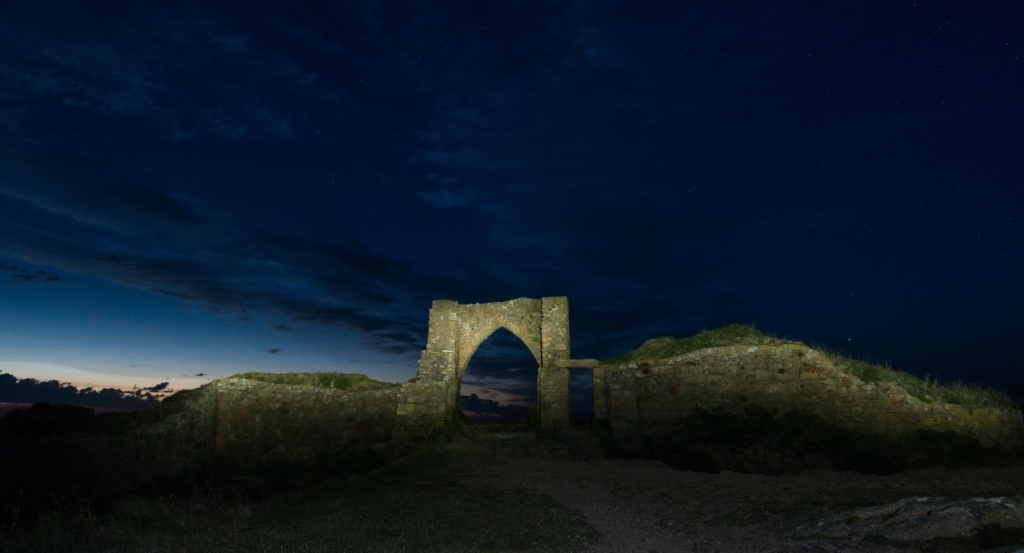 Grosnez Castle ruins after sunset by torch, St. Ouen, Jersey, Channel Islands