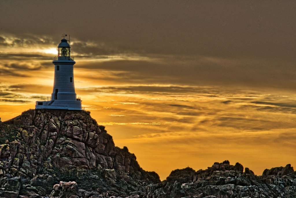 HDR version of the rocks and sunset at Corbiere Lighthouse, St. Brelade, Jersey, Channel Islands