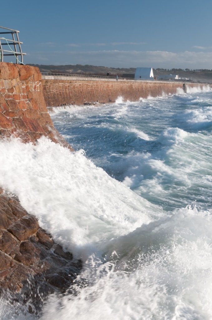 La Caumine a Marie Best (The White House) from L'Ouziere Slip, St. Ouen's Bay, St. Peter, Jersey, Channel Islands, at high tide with strong winds, rough sea and big waves