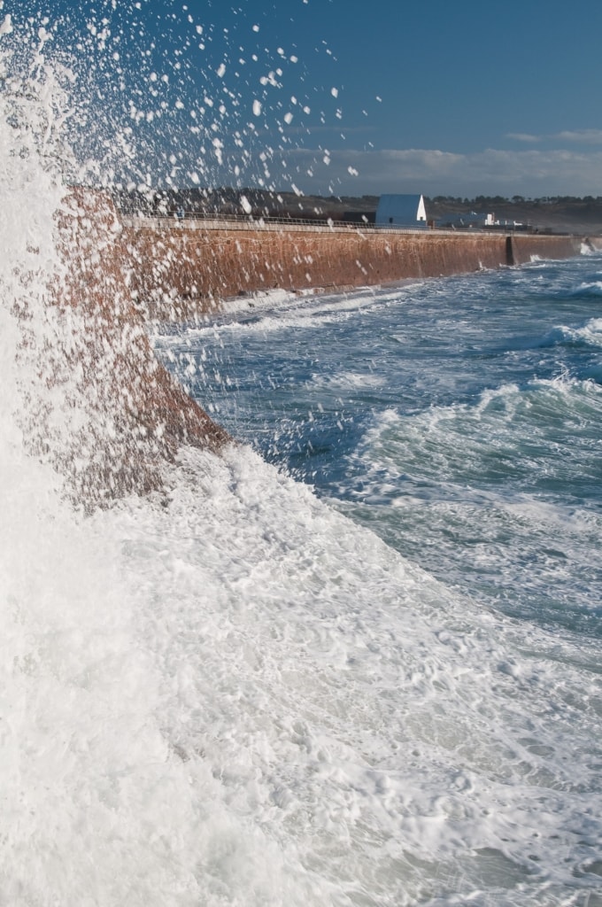 La Caumine a Marie Best / The White House viewed from L'Ouziere Slip, St. Ouen's Bay, St. Peter, Jersey, Channel Islands at high tide with strong winds, rough sea and big waves