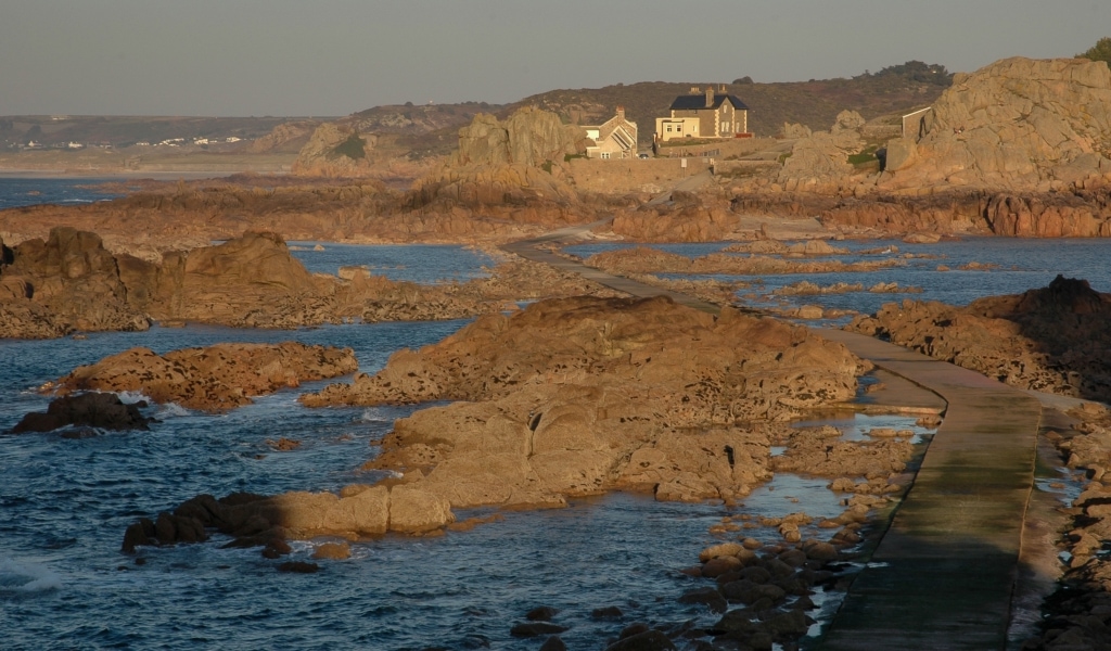 View looking inland in the evening from the causeway out to Corbiere Lighthouse, St. Brelade, Jersey, Channel Islands