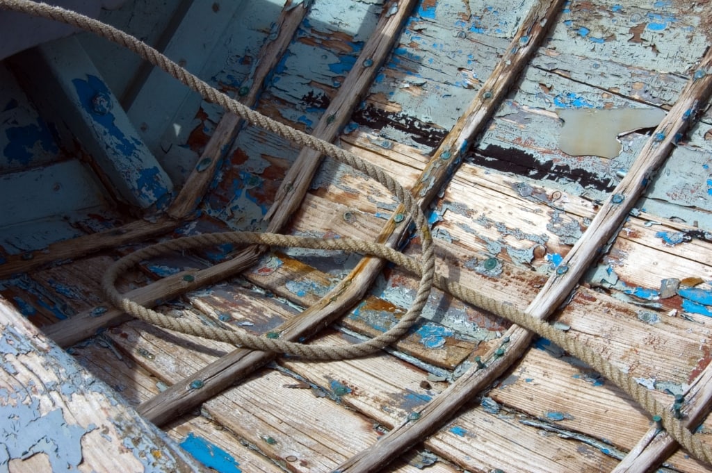 Old rowing boat on St. Aubin's Pier at St. Aubin's Harbour, St. Aubin, St. Brelade, Jersey, Channel Islands