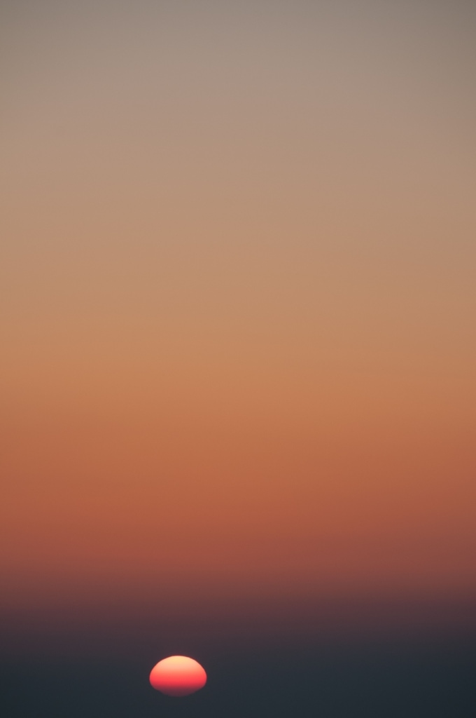 Orange gradient sunset over the sea near Corbiere, St. Brelade, Jersey, Channel Islands