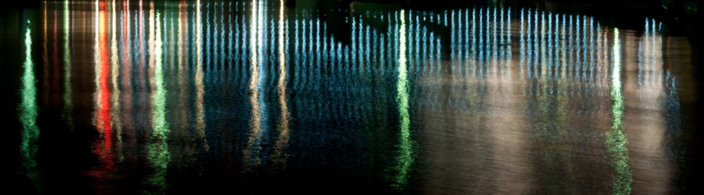 Promenade lighting reflected in the water at St. Aubin's Harbour, St. Aubin, St. Brelade, Jersey, Channel Islands