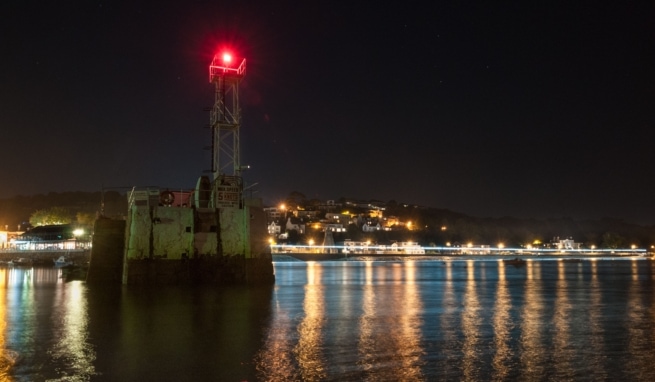 Promenade lighting reflected in the water at St. Aubin's Pier, St. Aubin's Harbour, St. Aubin, St. Brelade, Jersey, Channel Islands