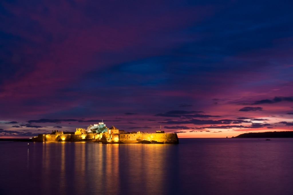 Purple sunset and Illuminated Elizabeth Castle, St. Helier Marina, St. Helier, Jersey, Channel Islands