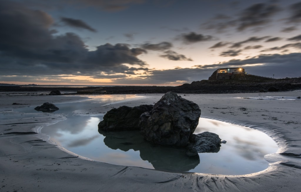 Rock pool on the beach at sunset, taken in front of Faulkner Fisheries at L'Etacq, St. Ouen, Jersey, Channel Islands