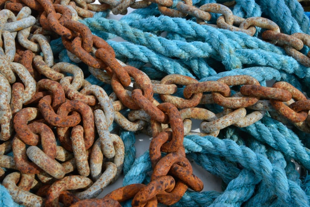 Close up of tangled ropes and chains on a boat at Ouaisne, St. Brelade, Jersey, Channel Islands