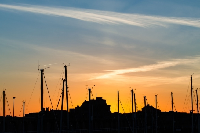 Silhouette of boat masts and Elizabeth Castle at sunset, St. Helier Marina, St. Helier, Jersey, Channel Islands