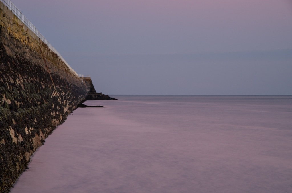 View looking down St. Catherine's Breakwater at sunset, St. Martin, Jersey, Channel Islands