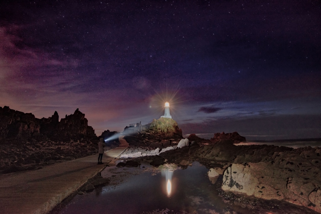 Stars and torch light at Corbiere Lighthouse, St. Brelade, Jersey, Channel Islands