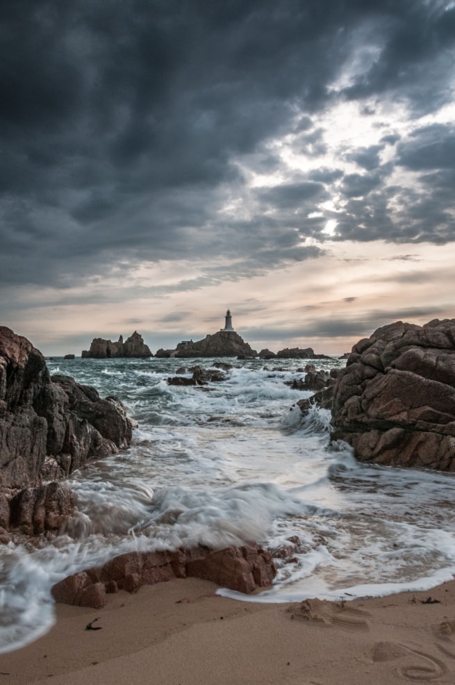 Stormy sky and waves at Corbiere Lighthouse, St. Brelade, Jersey, Channel Islands