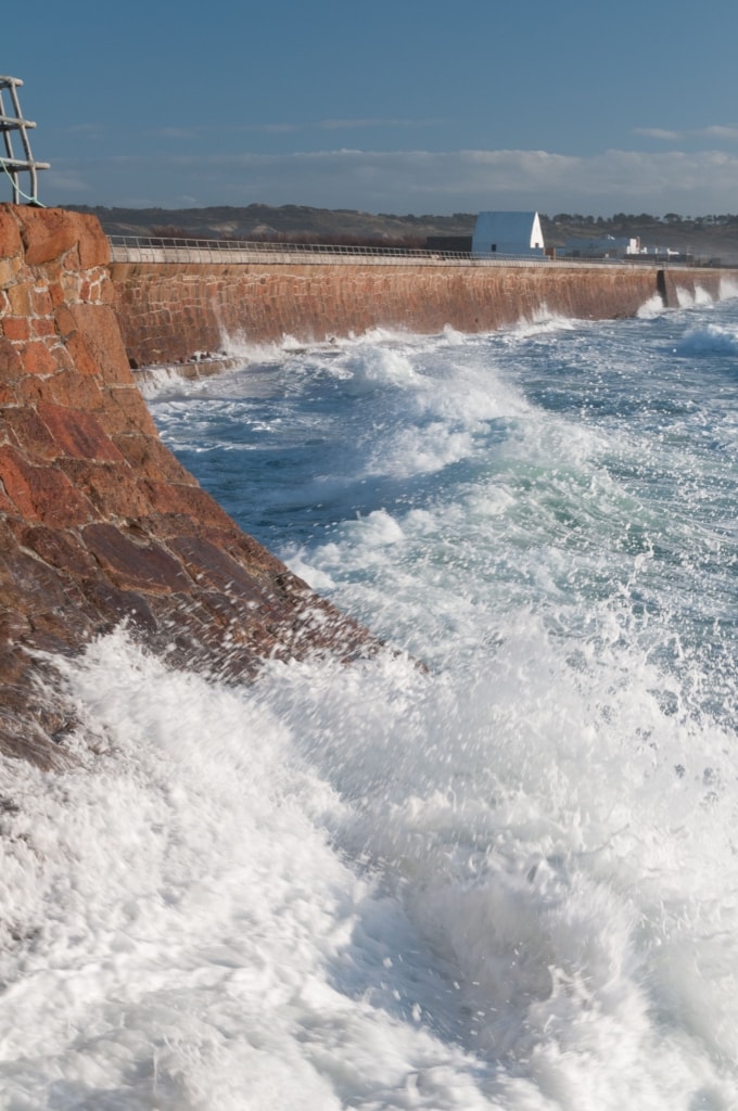 La Caumine a Marie Best / The White House viewed from L'Ouzière Slip, St. Ouen's Bay, St. Peter, Jersey, Channel Islands at high tide with strong winds, rough sea and big waves