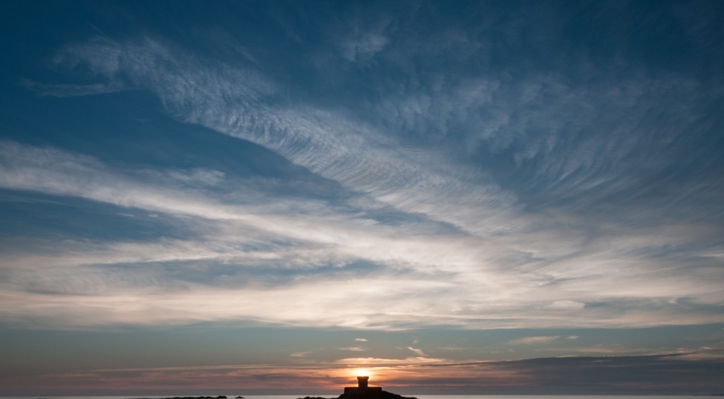 Sunset behind La Rocco Tower, Le Braye, St. Brelade, Jersey, Channel Islands