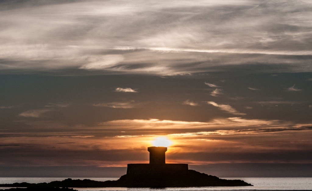 Sunset behind La Rocco Tower, Le Braye, St. Brelade, Jersey, Channel Islands