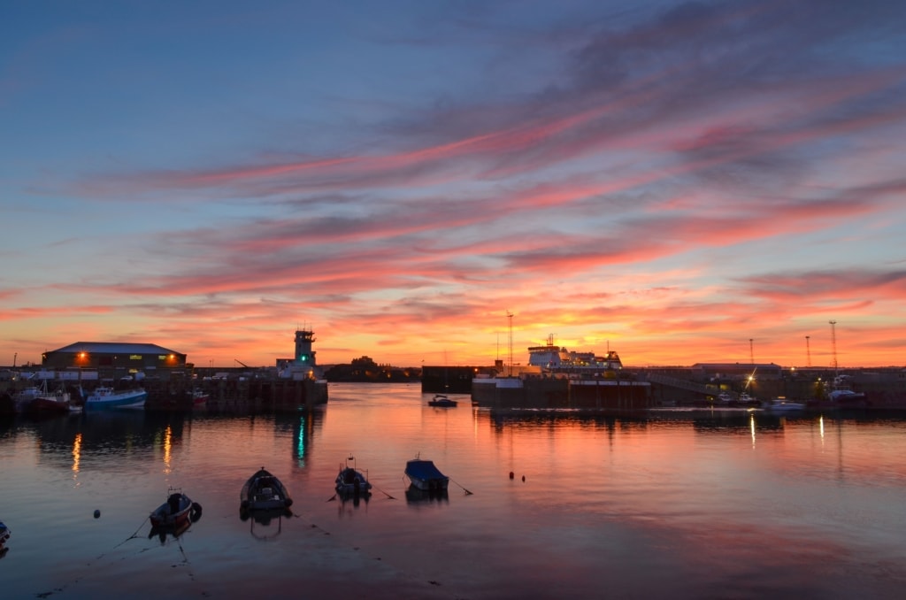 Beautiful sunset looking across St. Helier Harbour towards the Port Control Tower and Elizabeth Castle, St. Helier, Jersey, Channel Islands