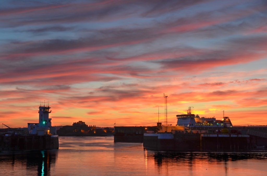 Beautiful sunset looking across St. Helier Harbour towards the Port Control Tower and Elizabeth Castle, St. Helier, Jersey, Channel Islands