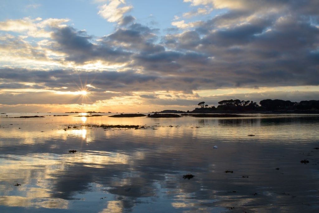 Sunset clouds reflected in the sand and water at Le Hocq, St. Clement, Jersey, Channel Islands