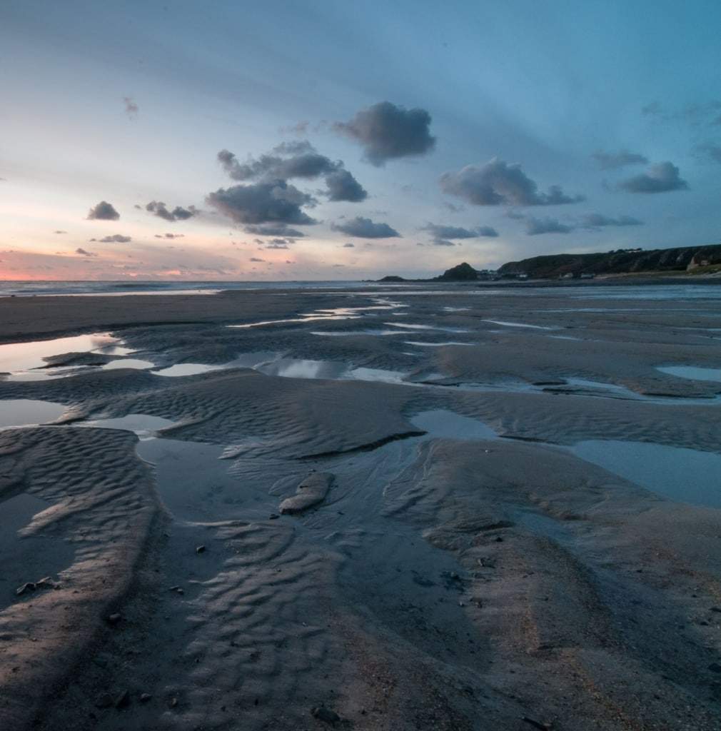 Sunset in the sand puddles at St. Ouen's Bay, St. Ouen, Jersey, Channel Islands