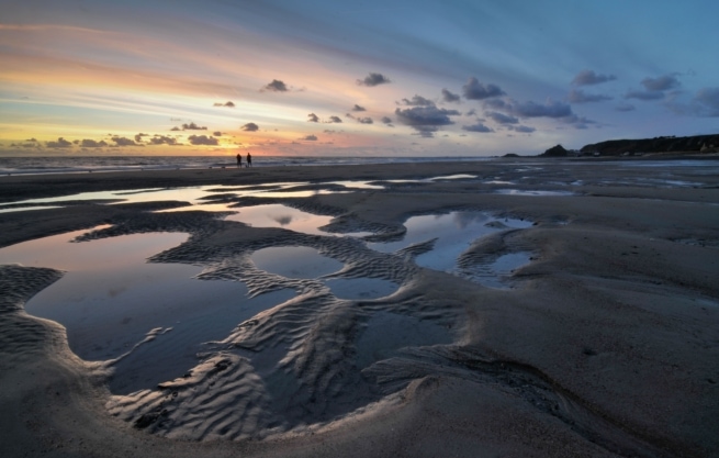 Sunset in the sand puddles at St. Ouen's Bay, St. Ouen, Jersey, Channel Islands