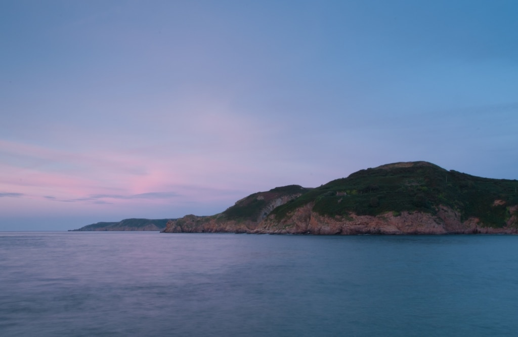 Sunset light at Greve De Lecq looking along the North Coast towards Sorel Point, St. Ouen, Jersey, Channel Islands