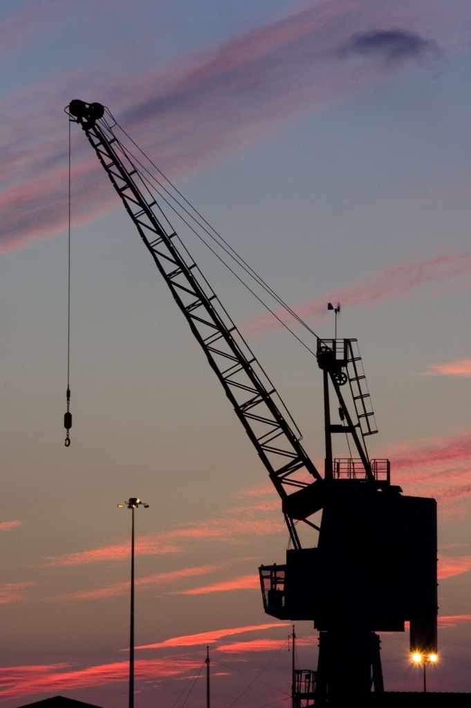 View of a crane on New North Quay at sunset from English Harbour, St. Helier Harbour, St. Helier, Jersey, Channel Islands