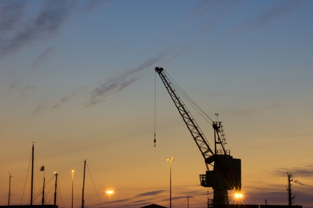 View of a crane on New North Quay at sunset from English Harbour, St. Helier Harbour, St. Helier, Jersey, Channel Islands