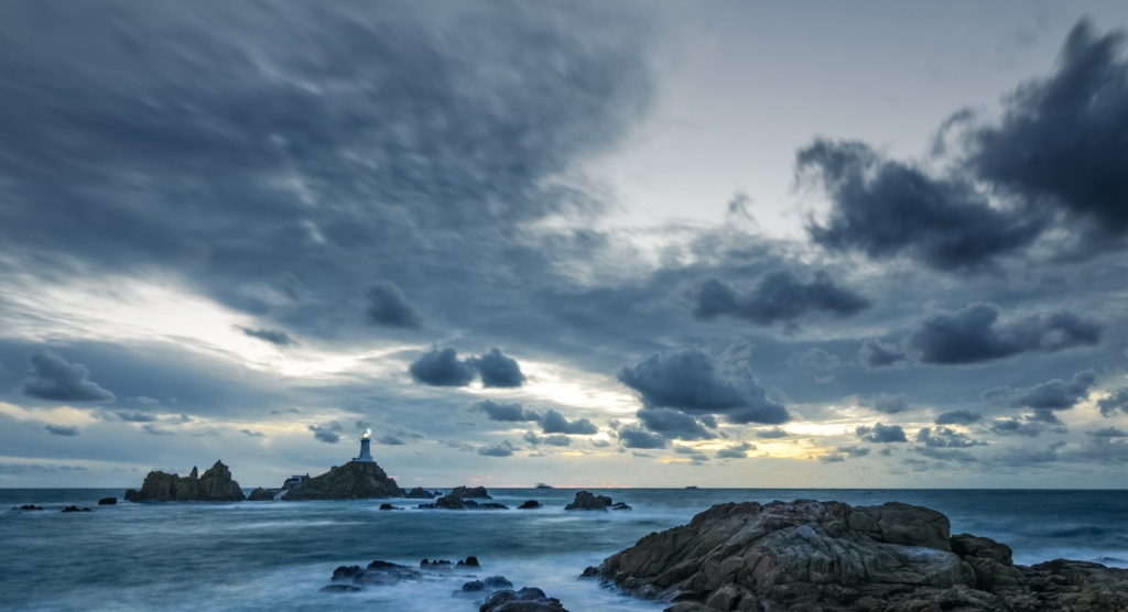 Windswept sea and clouds at sunset, Corbiere Lighthouse, St. Brelade, Jersey, Channel Islands